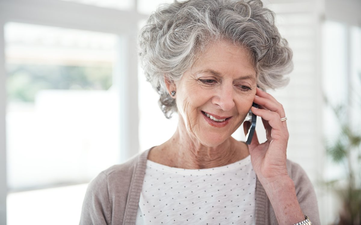 Woman speaking with her care coordinator on the phone at home